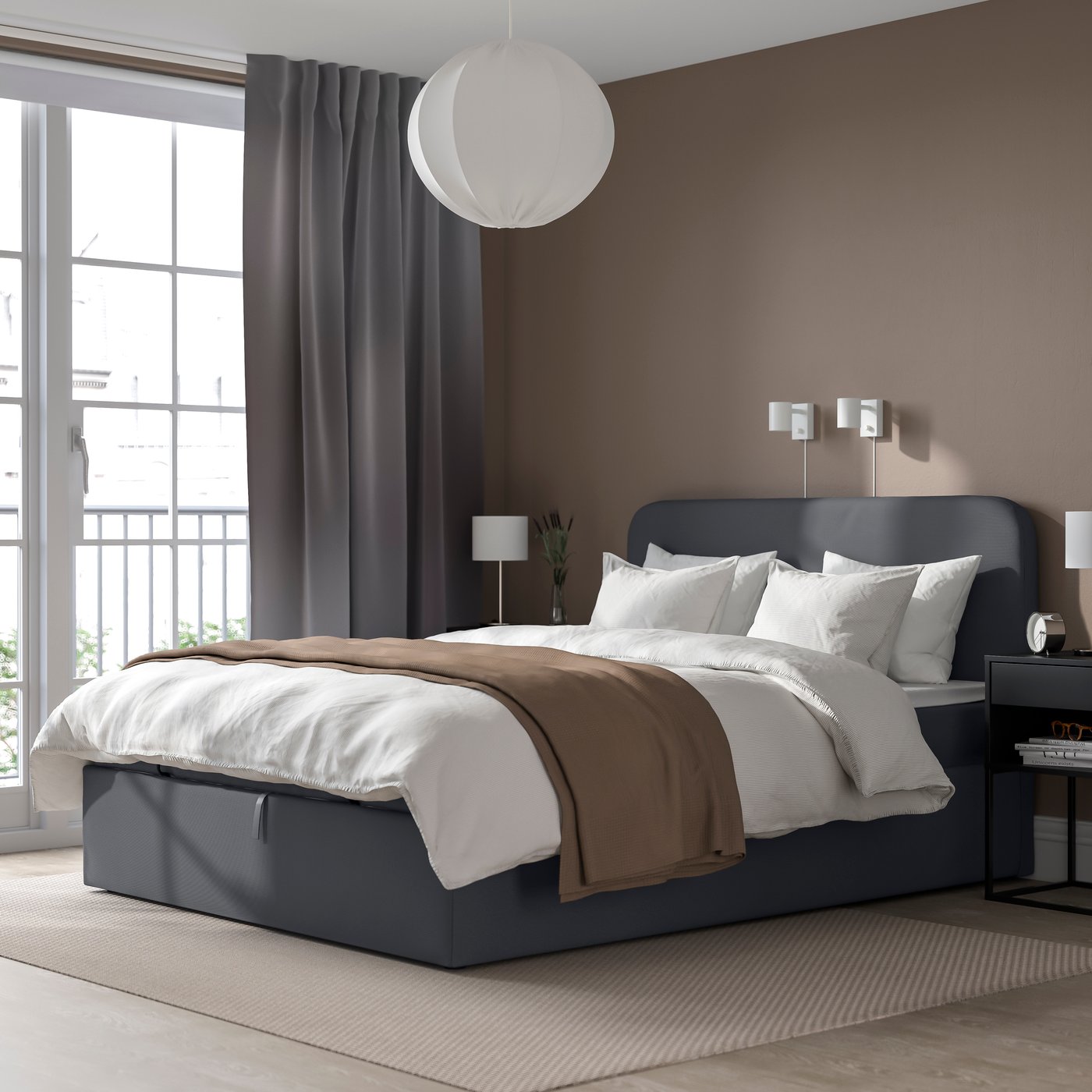 Modernt sovrum med en 160 cm bred bäddad säng i mörk ram, beige väggar, grå gardiner och en rund taklampa. Nattduksbord och lampor skapar en lugn, stilren atmosfär.