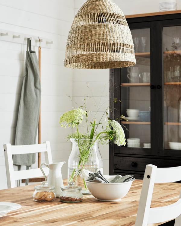 An acacia/black SKOGSTA dining table in the dining room