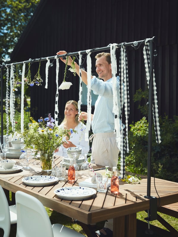 An outdoor/battery-operated black UTSUND LED lighting chain with 12 lights outside