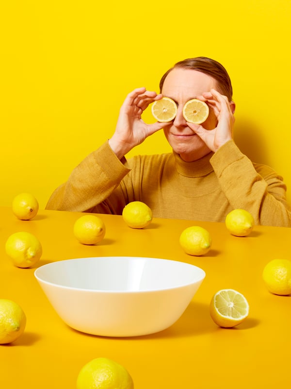 a person holding slices of lemons