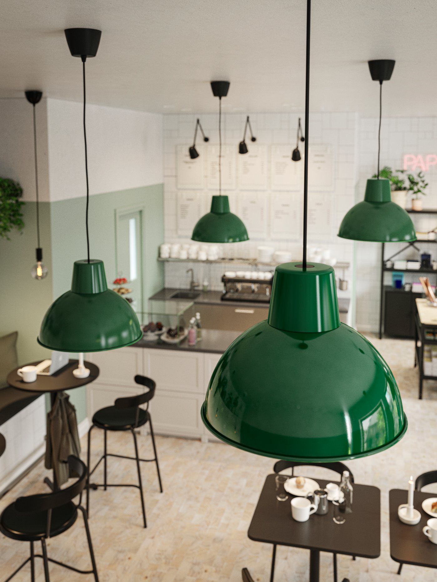 Dark green pendant lamps on the ceiling of a cafe, green and white walls, anthracite tables, chairs and a counter.