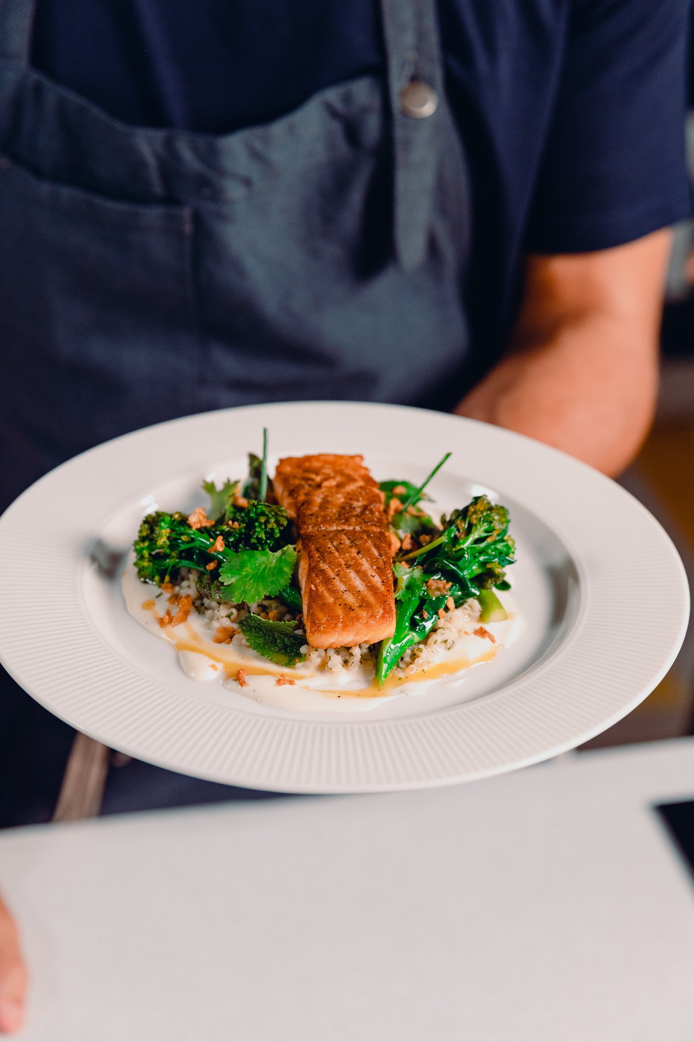 Chef Carlos Afonso cooking salmon with bulgur