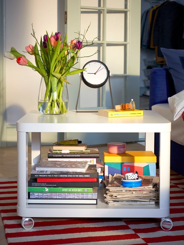 An yellow TJENA storage box with lid in the living room