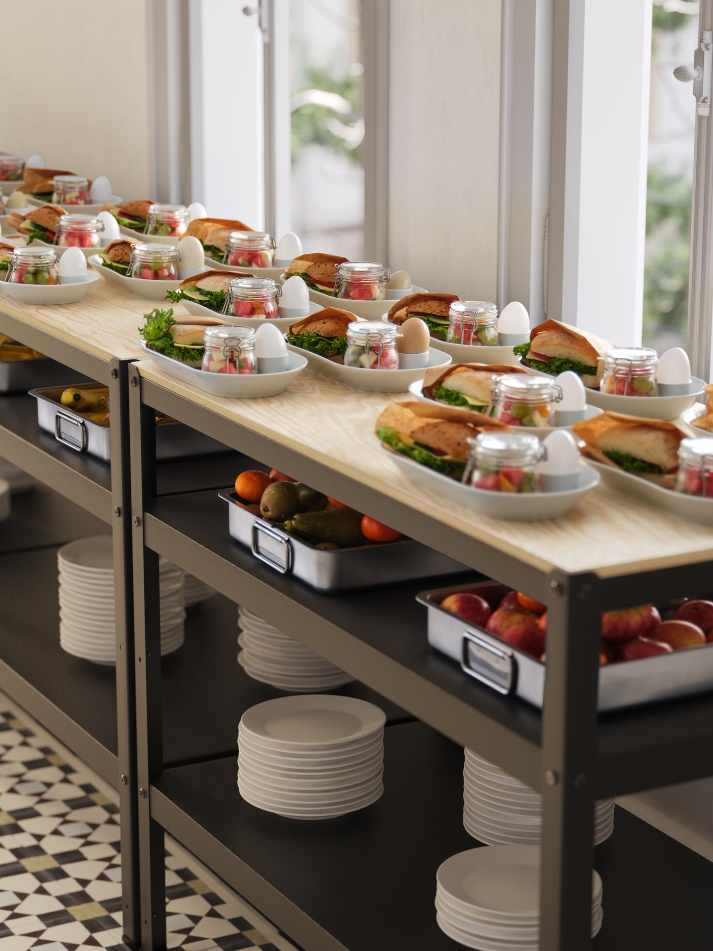 Many white oval plates filled with breakfast food, displayed on work benches next to a window.