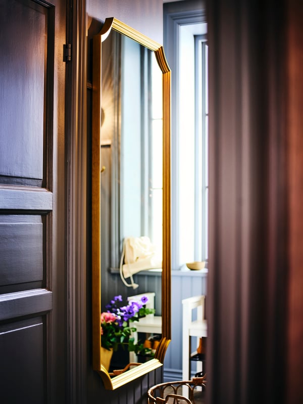 A light brown SILVERLÖNN sheer curtains, 1 pair, facing SVANSELE mirror.