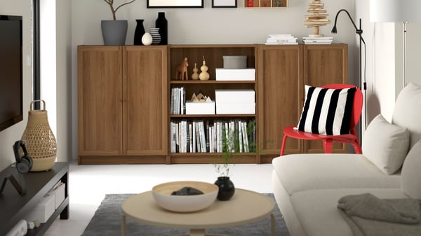 A brown walnut effect low BILLY bookcase combination with doors in the living room