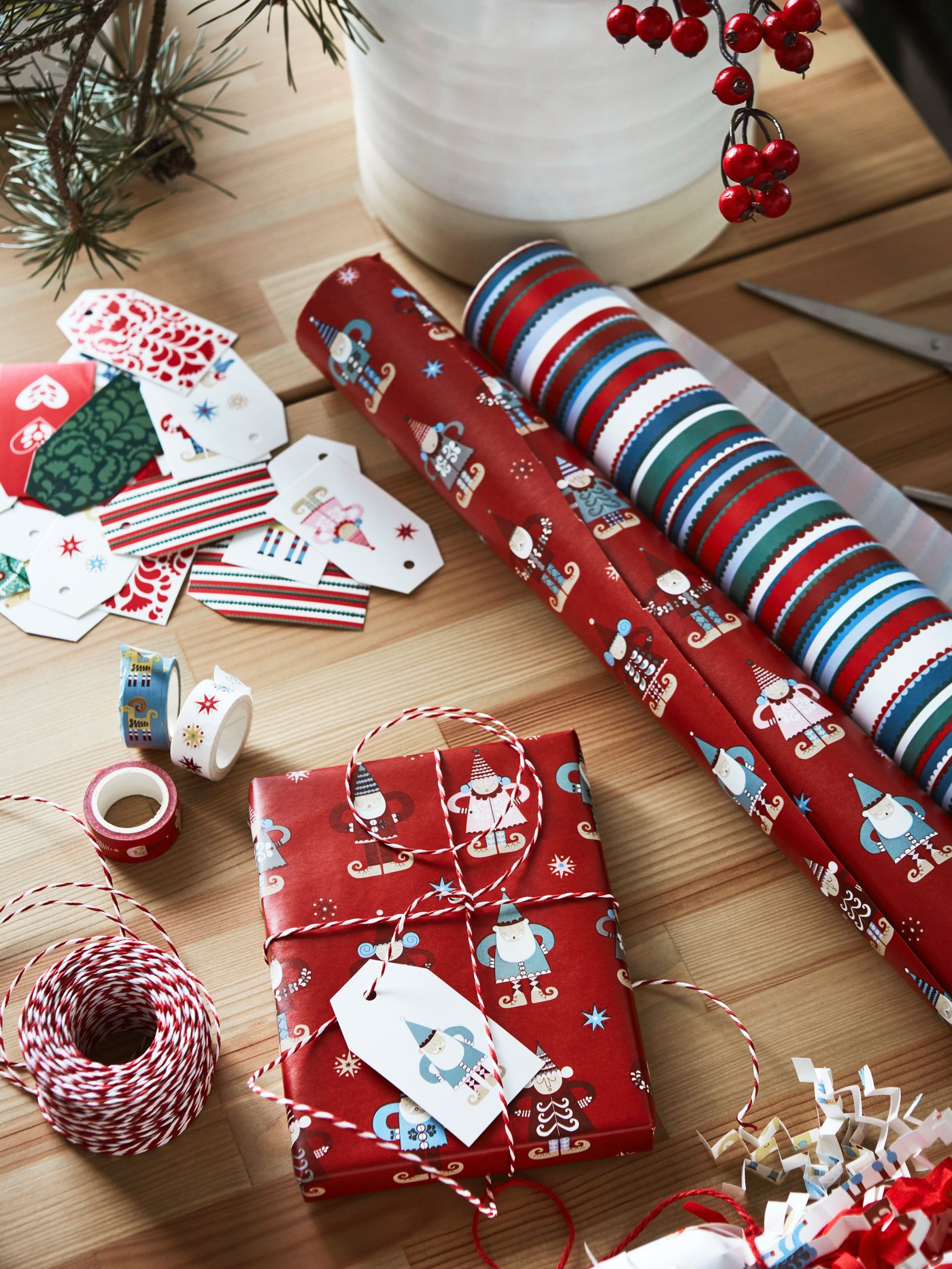 Rolls of VINTERFINT wrapping paper, decoration tape and VINTERFINT string and gift tags are on a wooden tabletop.