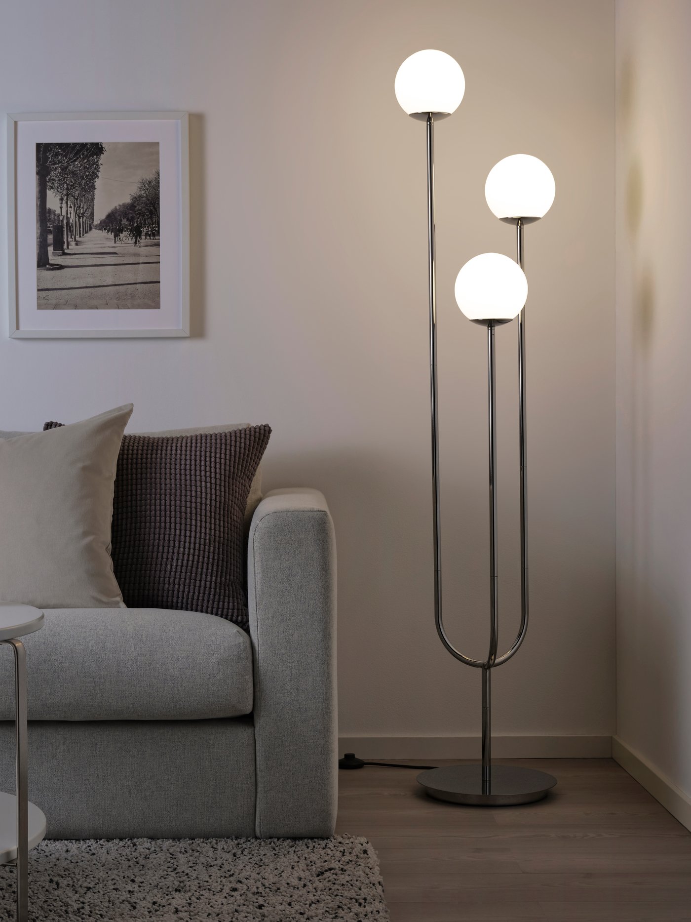 A chrome-plated/opal white glass SIMRISHAMN floor lamp