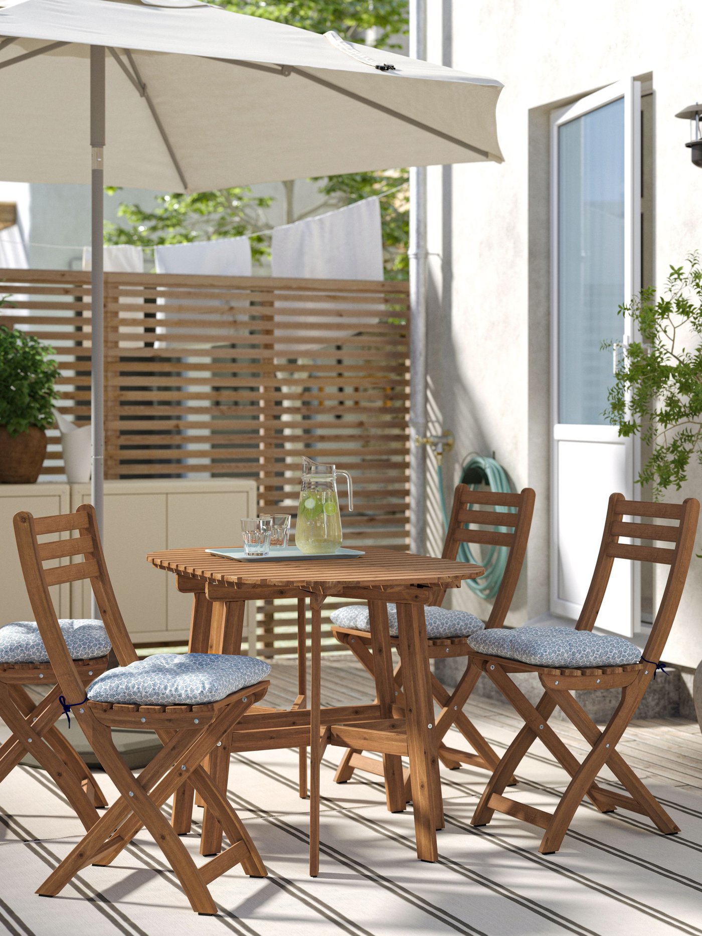 A dark brown ASKHOLMEN gateleg table, outdoor