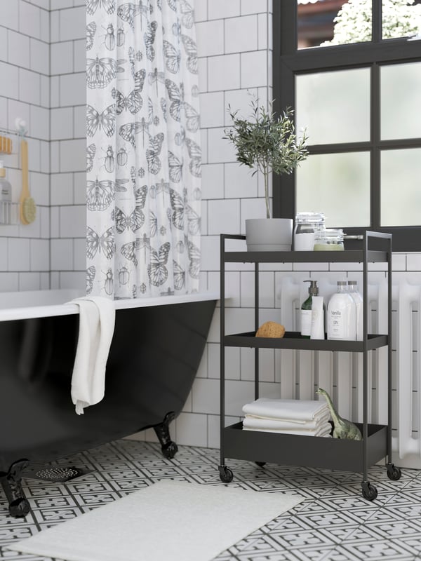 A black NISSAFORS trolley in the bathroom