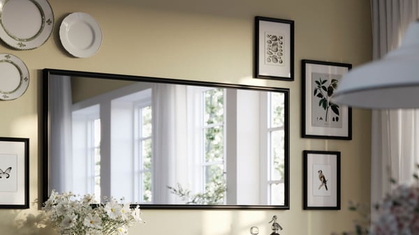 A black NYPONBUSKE mirror in the dining room