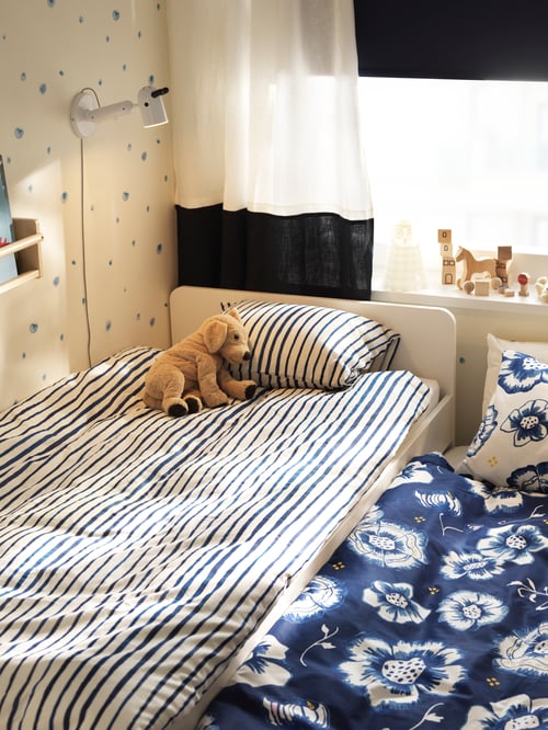 Child’s bedroom with a bed frame with underbed and storage, quilt covers and pillowcase set, soft toy, wall lamp with LED.