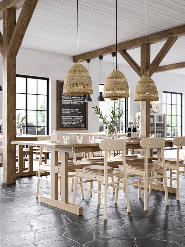 A light dining room with a large dining table big enough to fit 8 people.