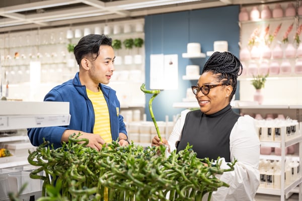 An IKEA co-worker helps a business owner shop in-store.