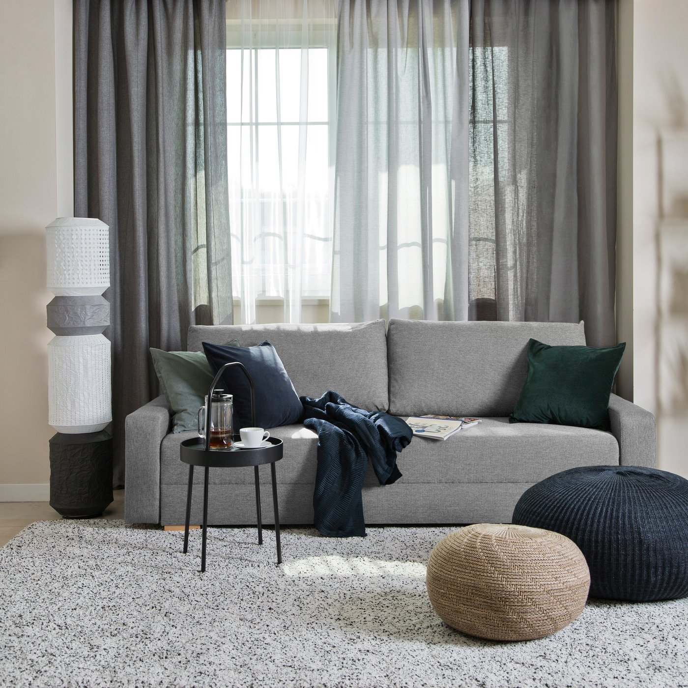 A grey GRÄLVIKEN 3-seat sofa-bed in the living room