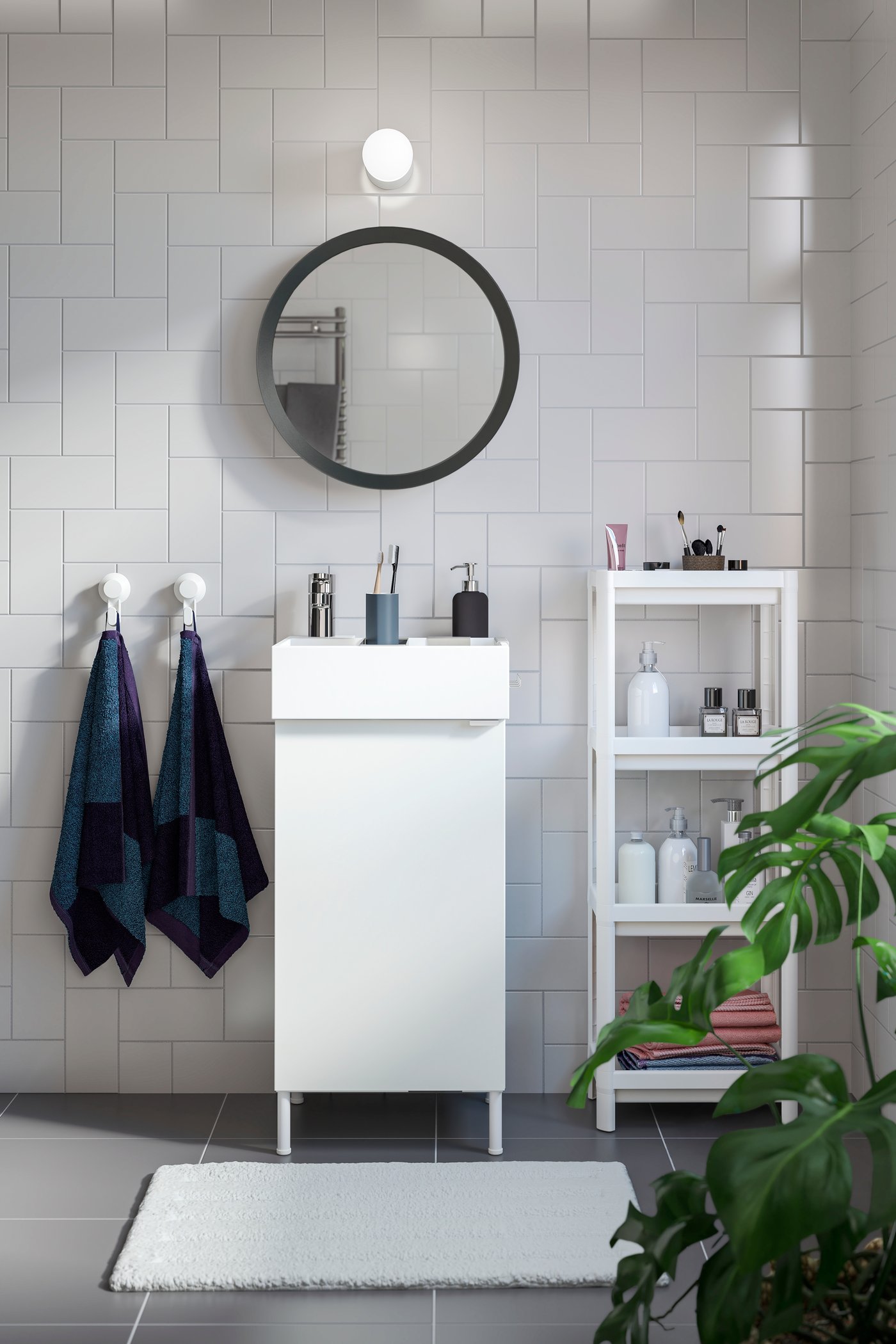 A white VESKEN shelf unit in the bathroom