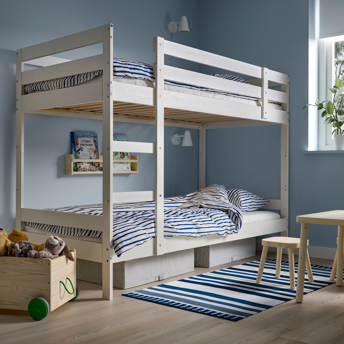 A white MYDAL bunk bed frame