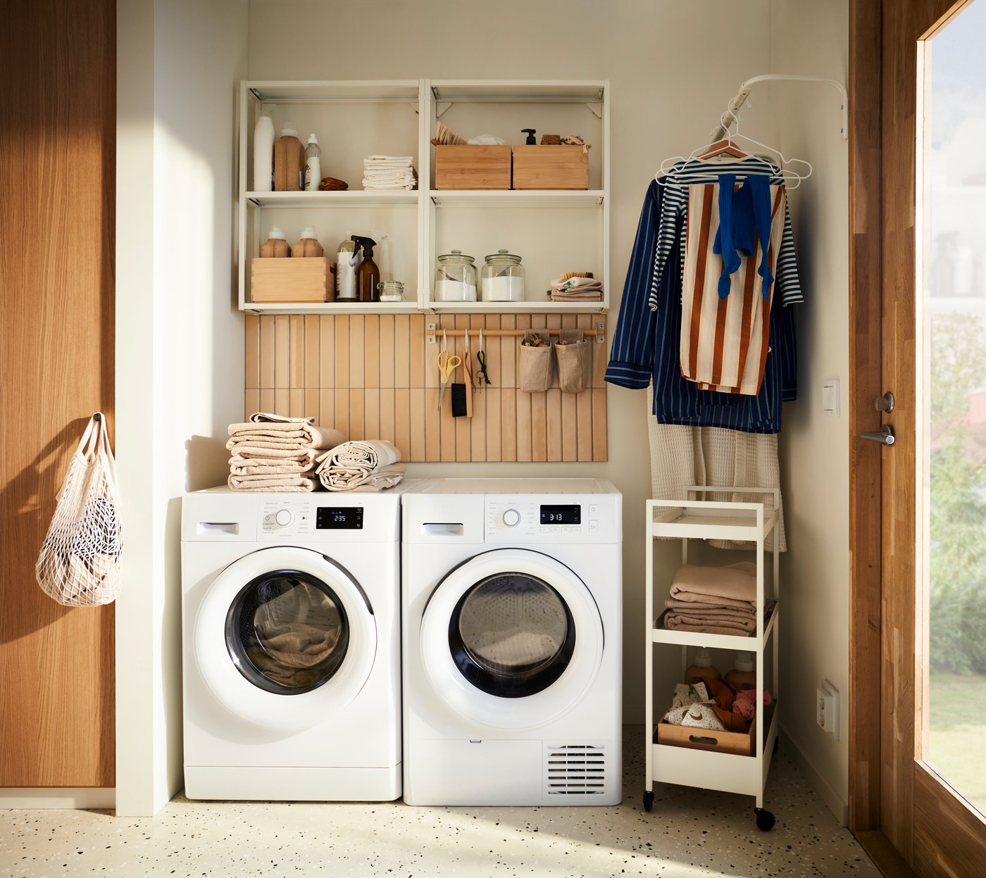 ENHET laundry combination open shelving in laundry room with washing machine and racks with clothes and shoe rack.