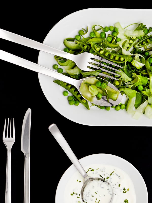 A stainless steel IKEA 365+ 24-piece cutlery set in the dining room