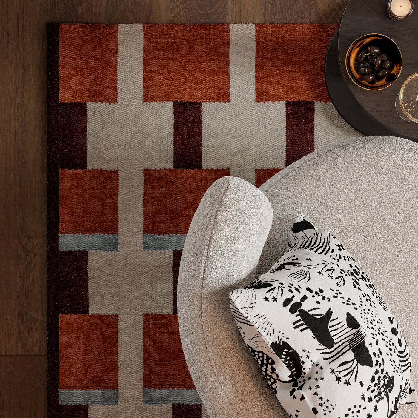 A cushion with a STOCKHOLM 2025 cushion cover lies on a STOCKHOLM 2025 armchair on a STOCKHOLM 2025 rug.