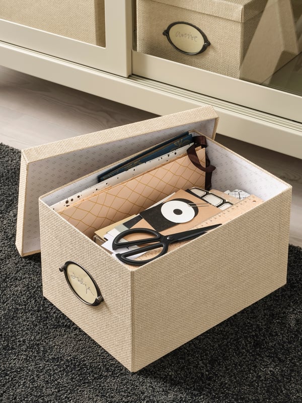 A beige KVARNVIK storage box with lid
