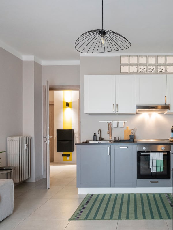 Interno di un appartamento con vista della cucina, della sala da pranzo e di parte del divano