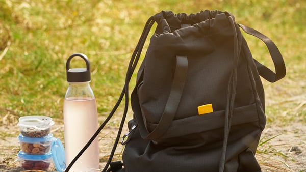 A dark grey IKEA 365+ water bottle outside