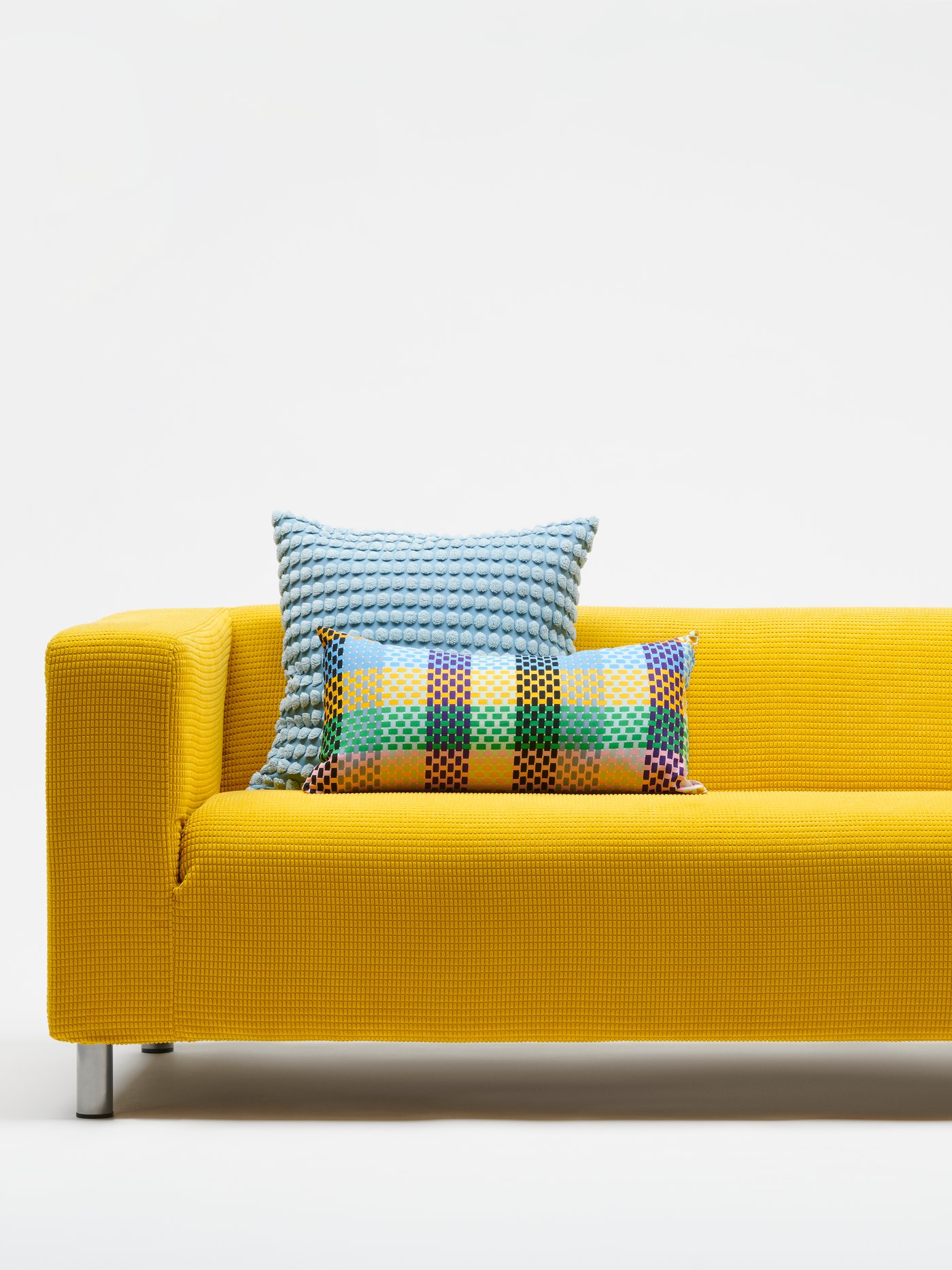 A Vansbro yellow KLIPPAN cover for 2-seat sofa