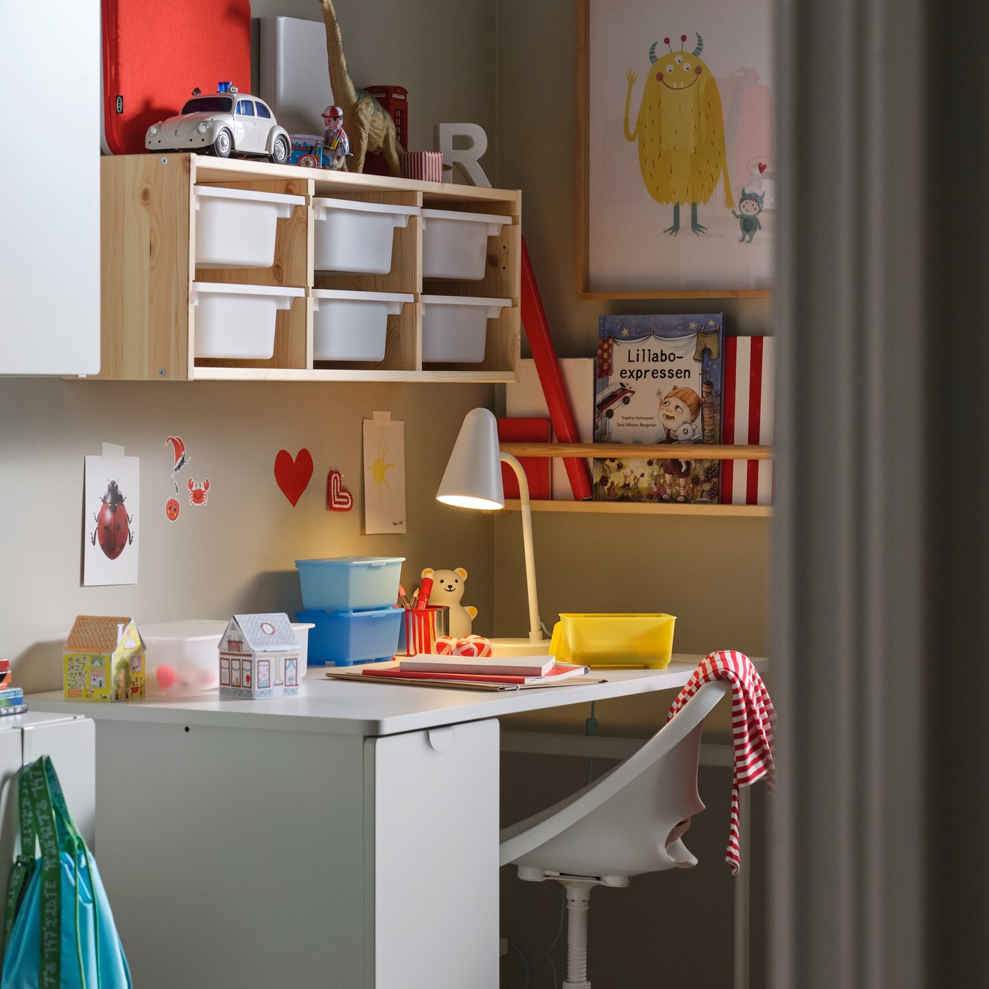 A light white stained pine/white TROFAST wall storage in the childrens room