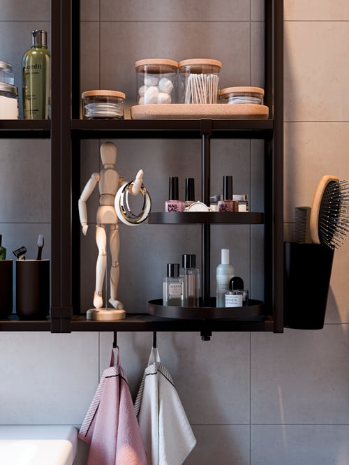 Bathroom with white tiles, black wall front with shelves, black swivel shelf, artist dummy, jars with lids, hand towels.