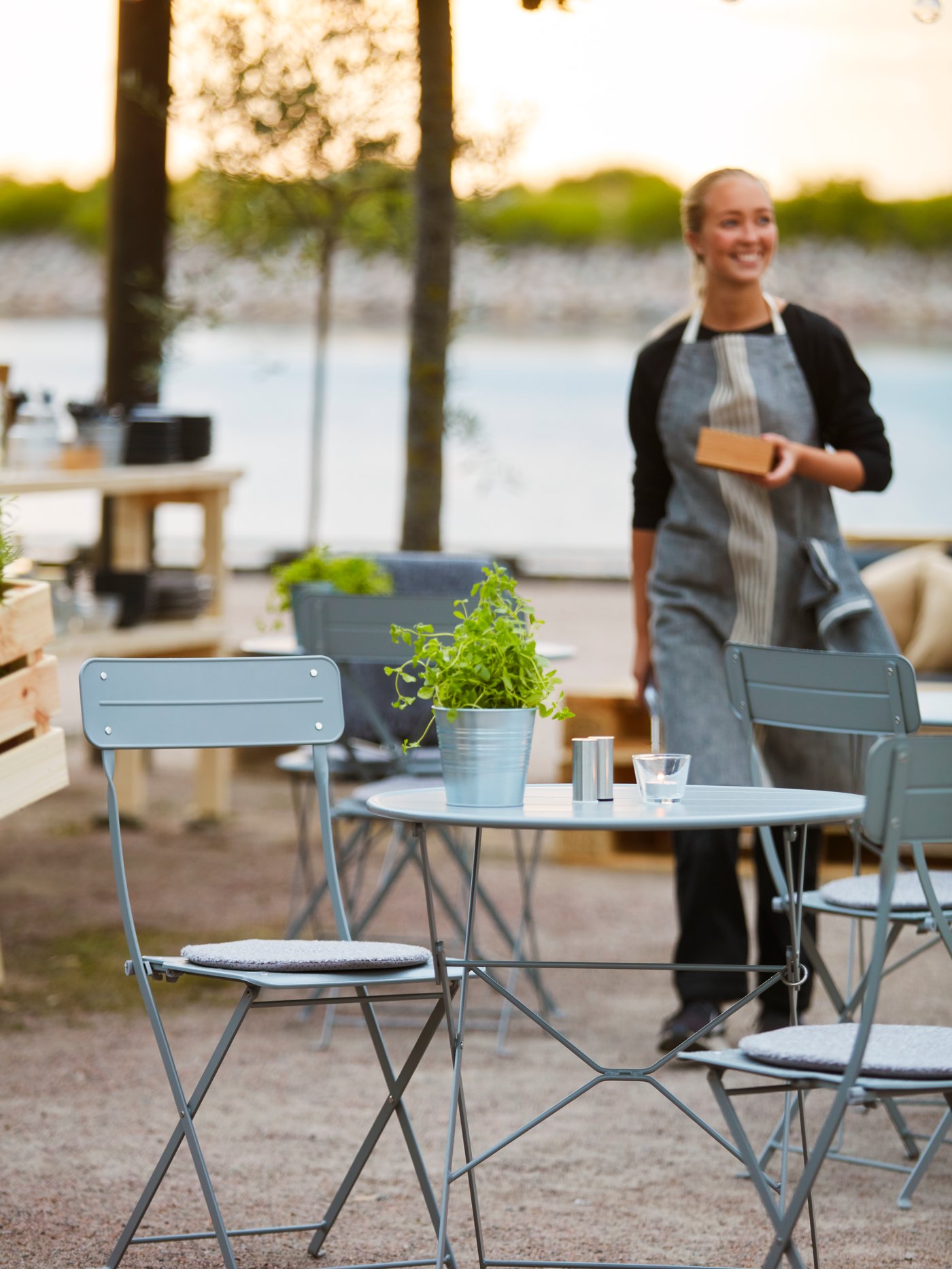 A terrace with light blue table and chairs.