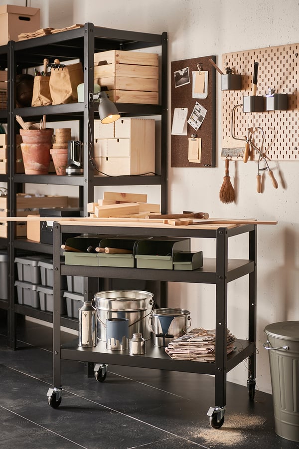 A BROR trolley in a garage environment. The trolley is filled with various items like tins and plastic boxes.