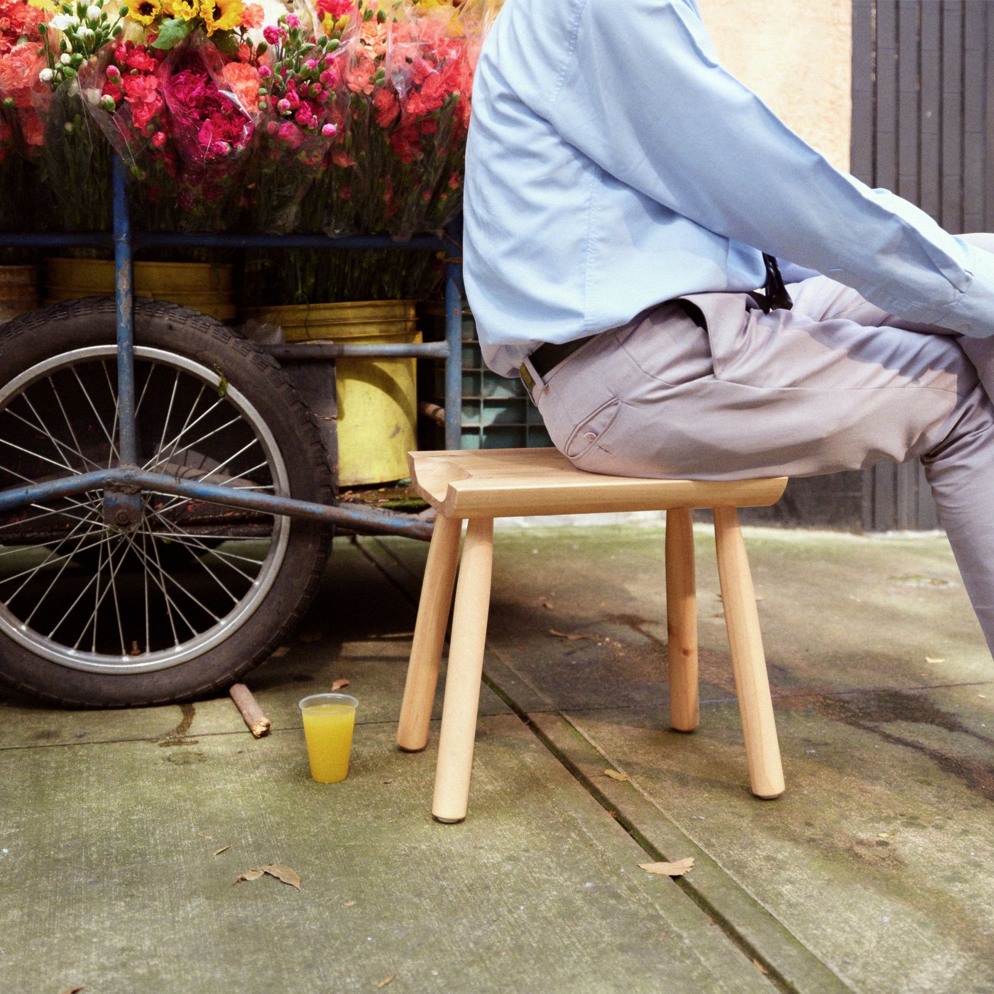 A pine ÖMSESIDIG stool outside