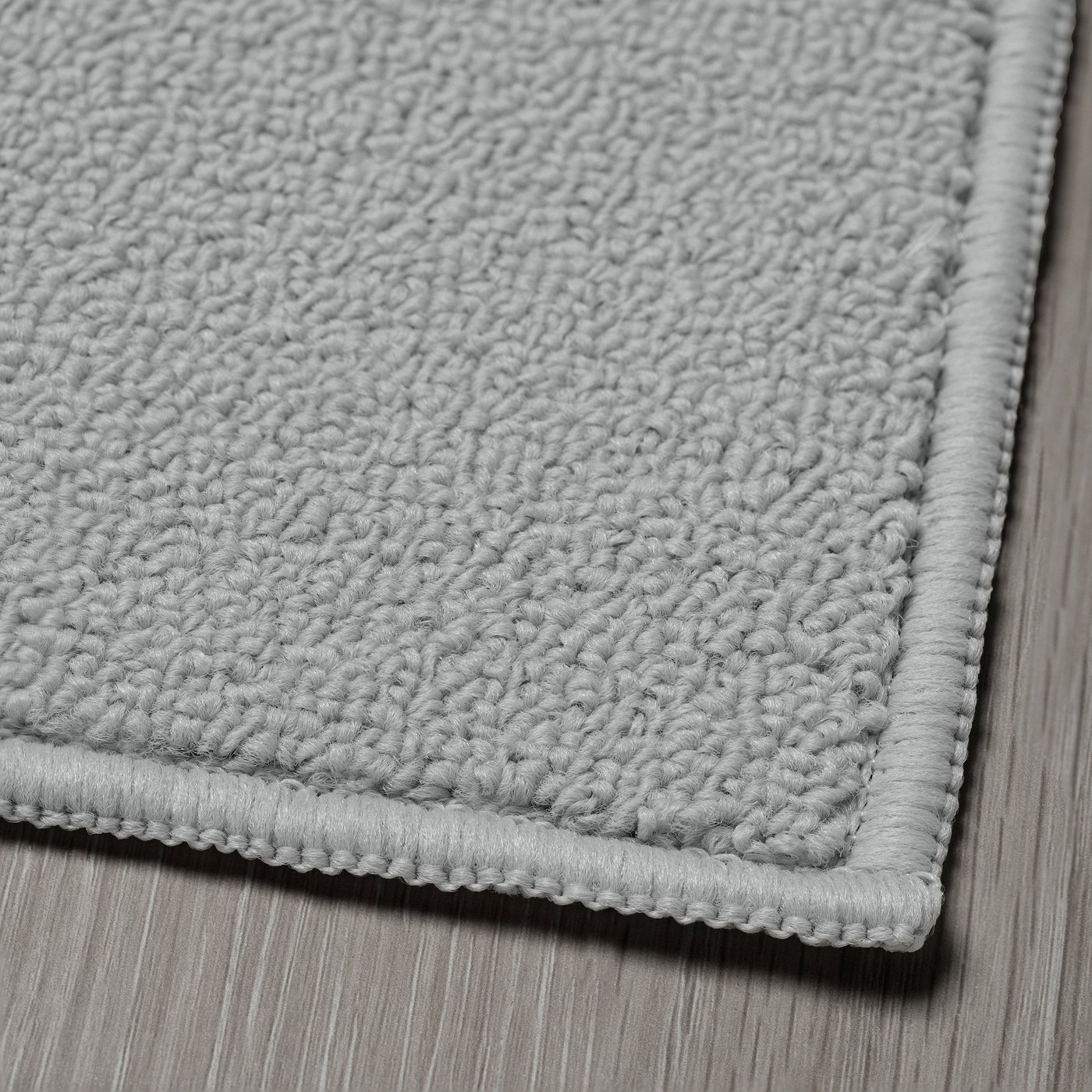 A light grey KÖRFÄLT kitchen mat