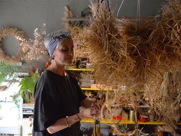 Laura working on her floral decorations in her workshop.