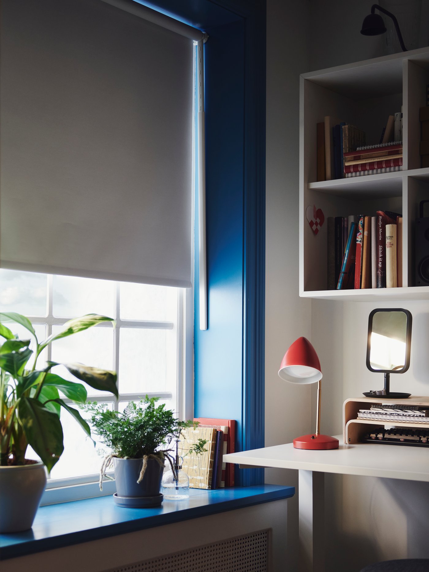 Half-lowered block-out roller blind, limiting the amount of light in a room