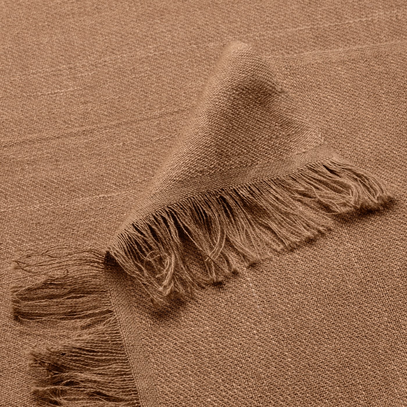 A light brown DYTÅG throw