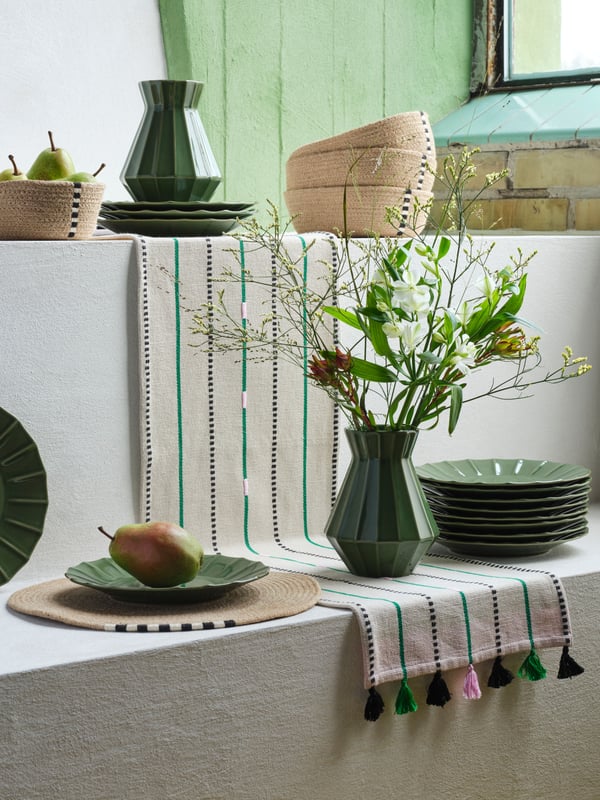 An off-white/green stripe MÄVINN table-runner