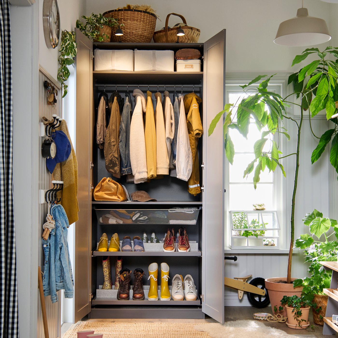 A PAX GULLABERG wardrobe with doors open to show the neat order inside with both shelves, hanging rods and shoe shelves.