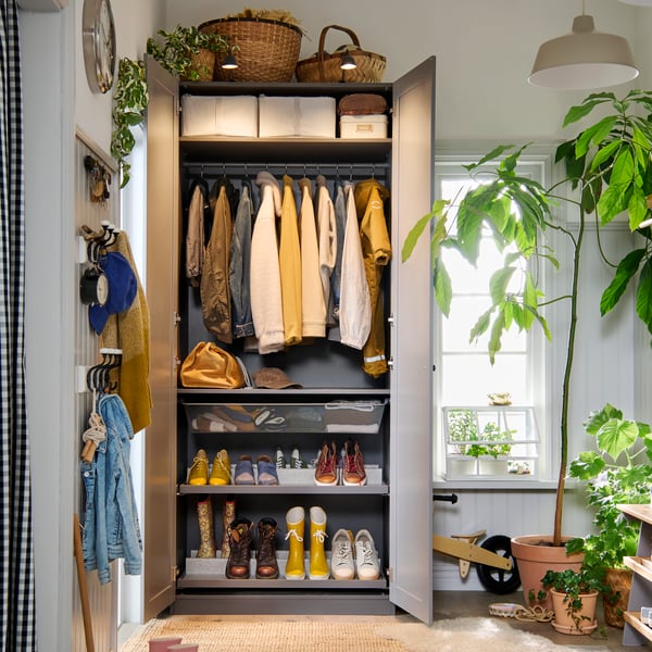 A PAX GULLABERG wardrobe with doors open to show the neat order inside with both shelves, hanging rods and shoe shelves.
