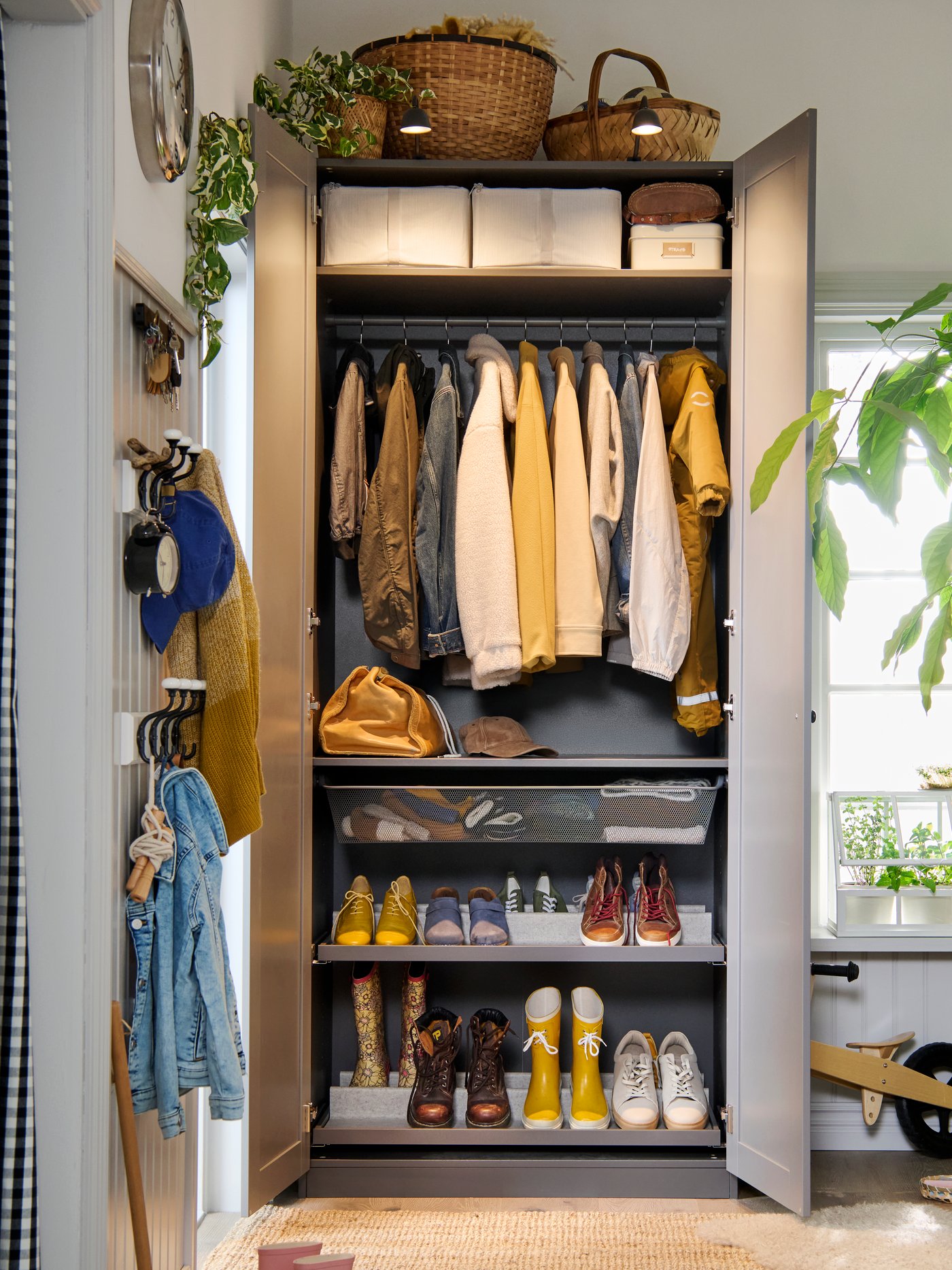 A PAX GULLABERG wardrobe with doors open to show the neat order inside with both shelves, hanging rods and shoe shelves.