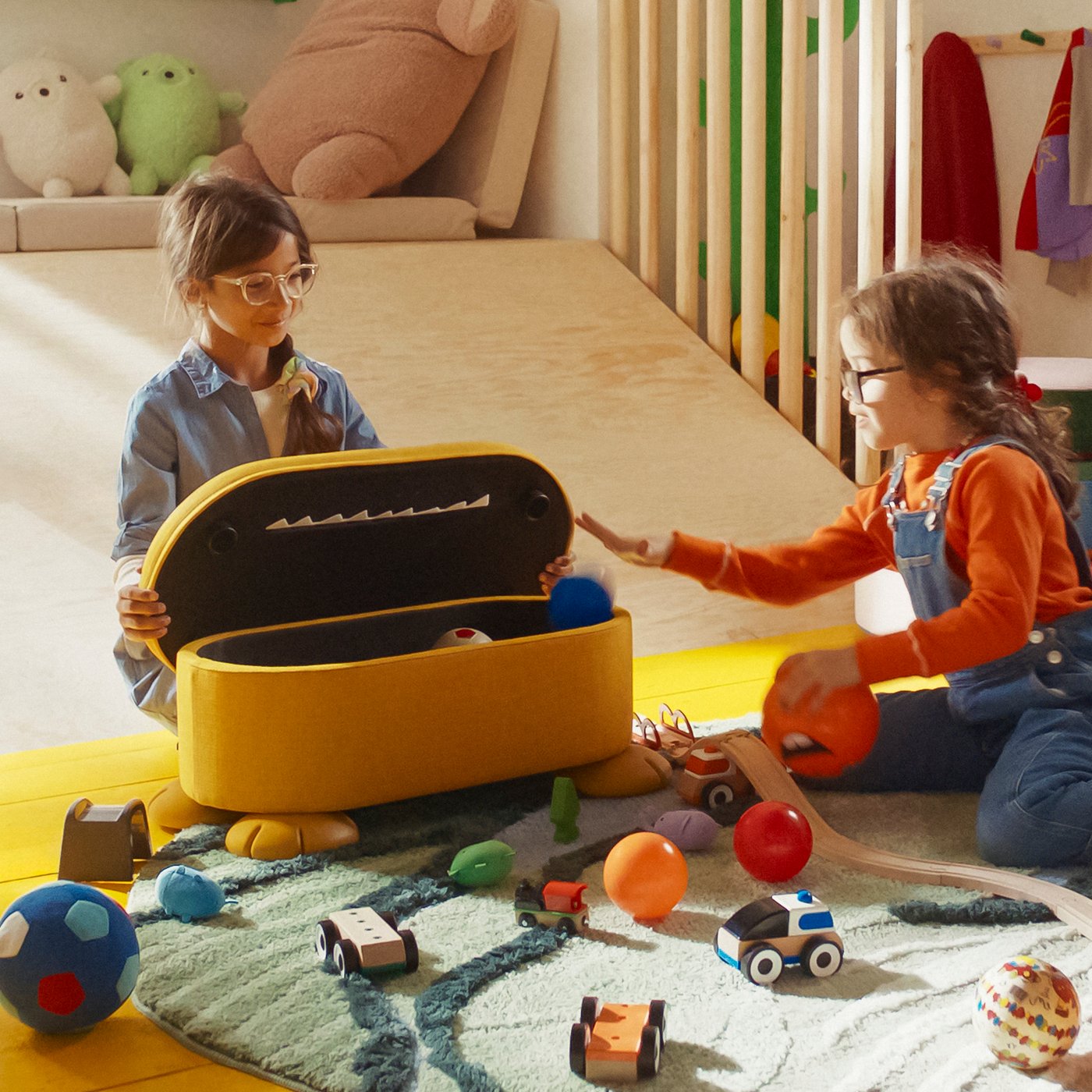An yellow GREJSIMOJS pouffe with storage in the childrens room