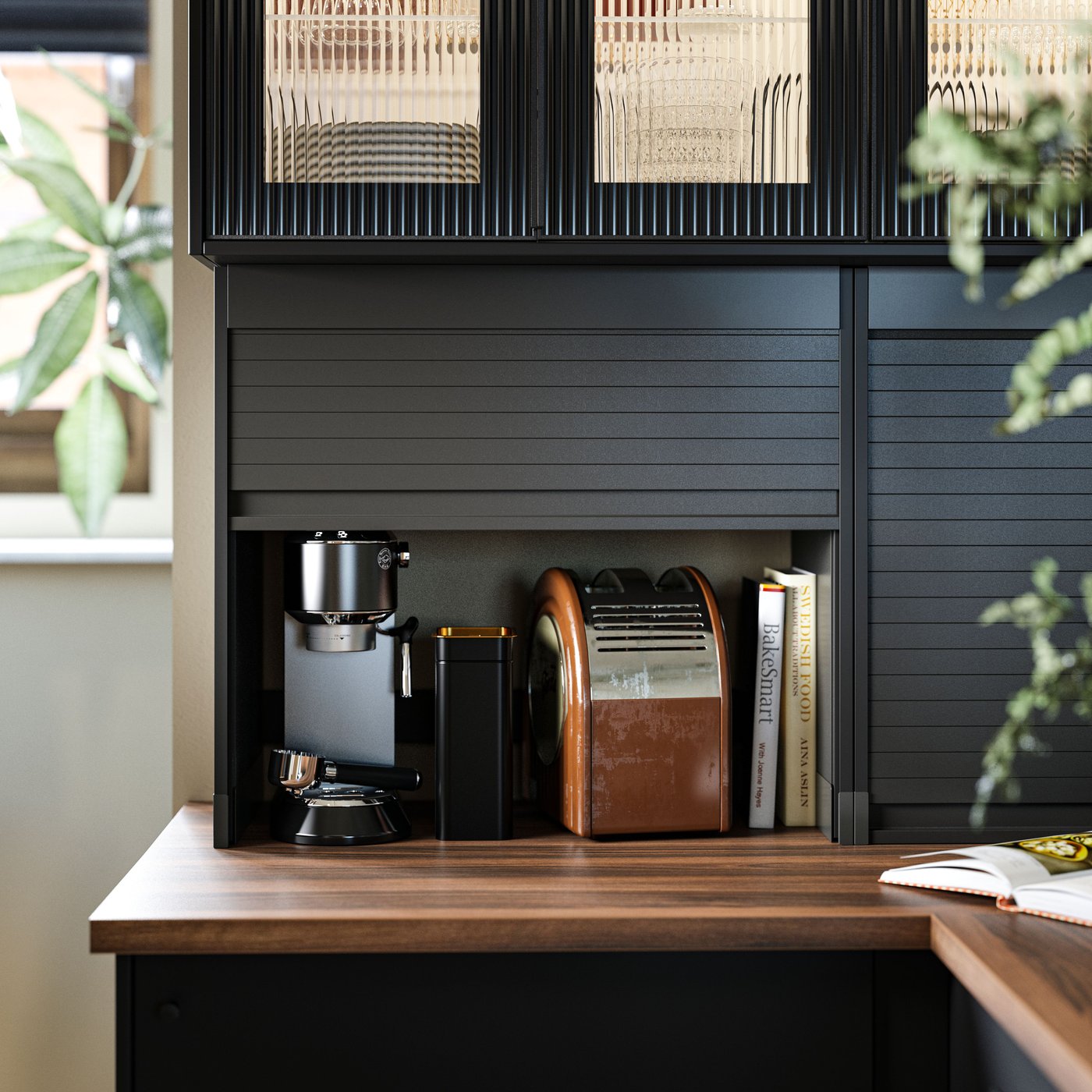 A kitchen with EKBACKEN worktop in brown walnut effect/laminate, with TITTEBO tambour storage, kitchen appliances and books.