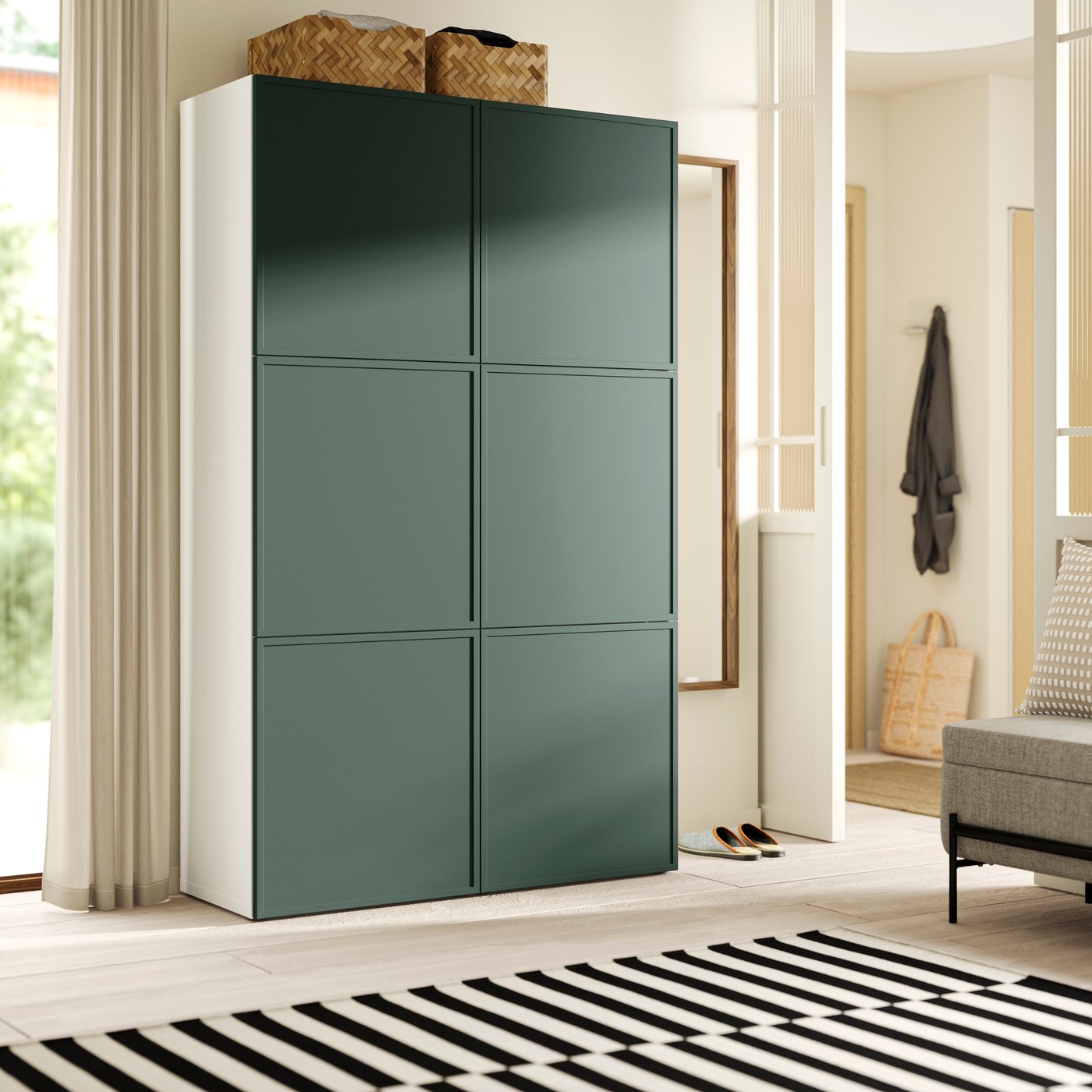 Tall white cabinet with six green doors, two woven baskets on top, in a bright modern room with striped rug.