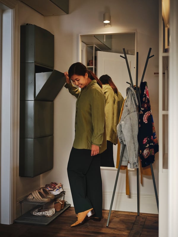 A grey-green GREJIG shoe rack
