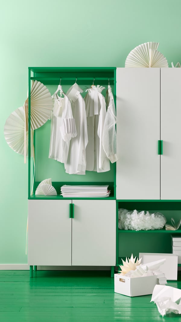 A white and green PLATSA wardrobe combination in front of a bright green wall.