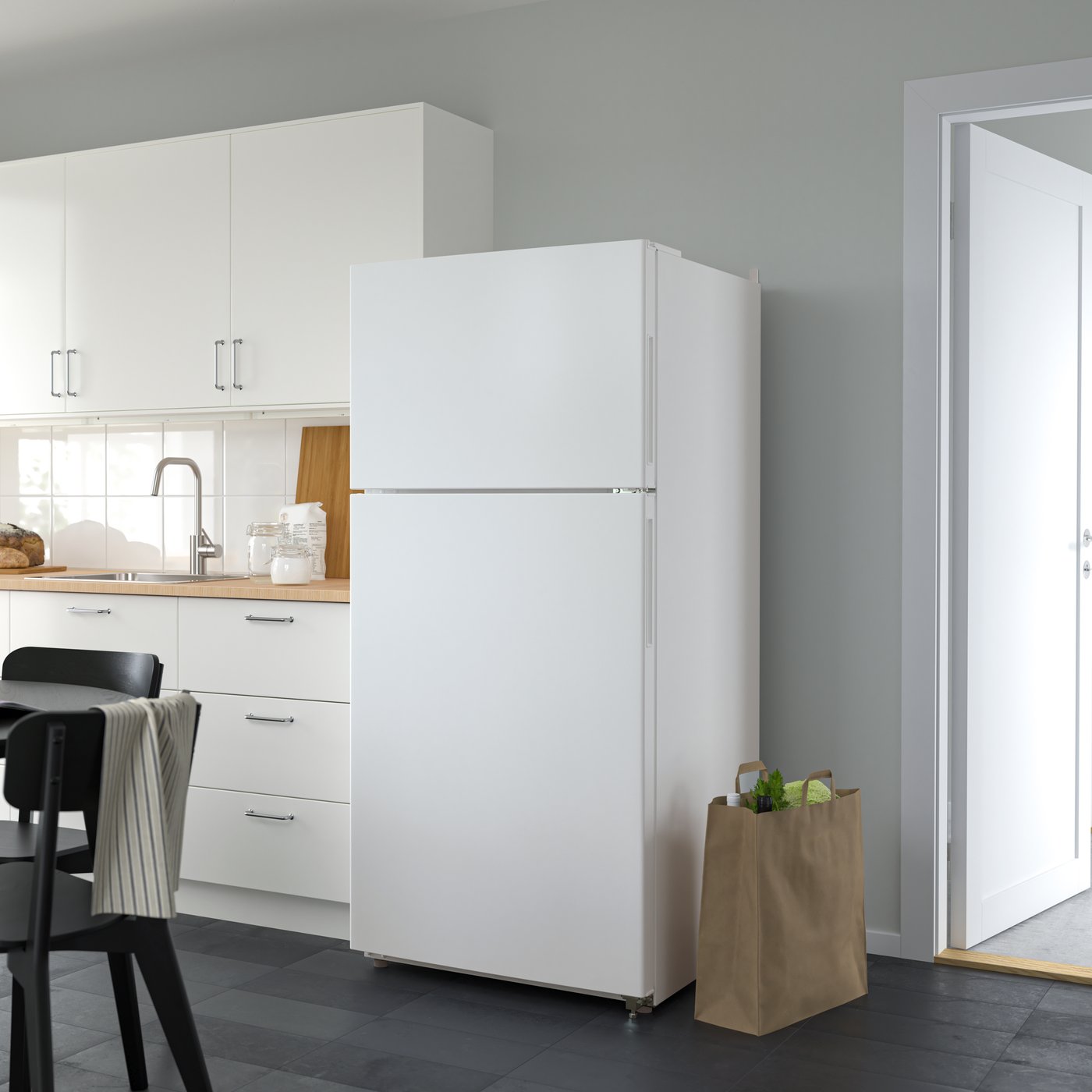 A white LAGAN top-freezer refrigerator.