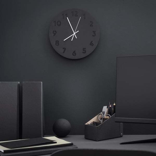A black TUNNIS wall clock