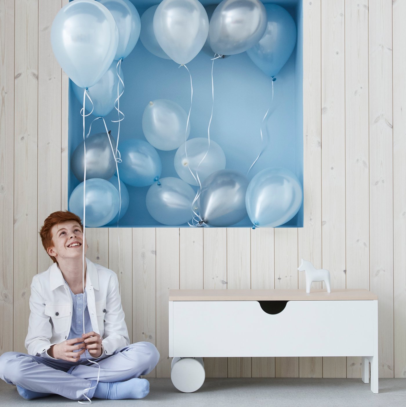 A white IKEA PS 1995 storage bench