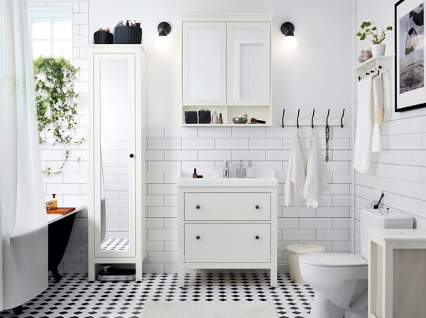 A white HEMNES high cabinet with mirror door
